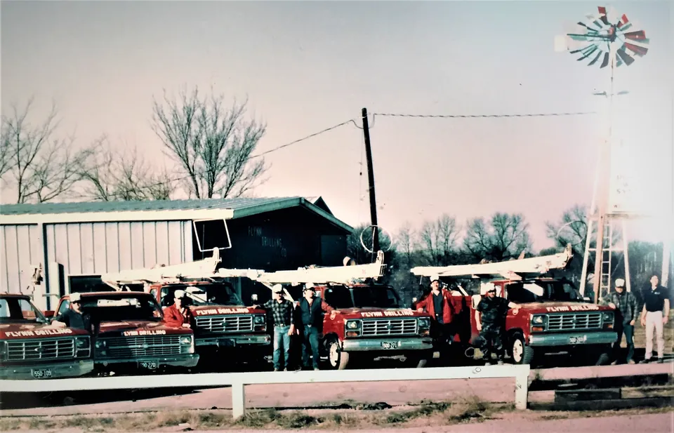 Flynn Drilling crews and rigs lined up outside the shop in the early years