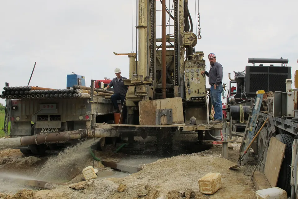Flynn rigs working beside a treatment lagoon