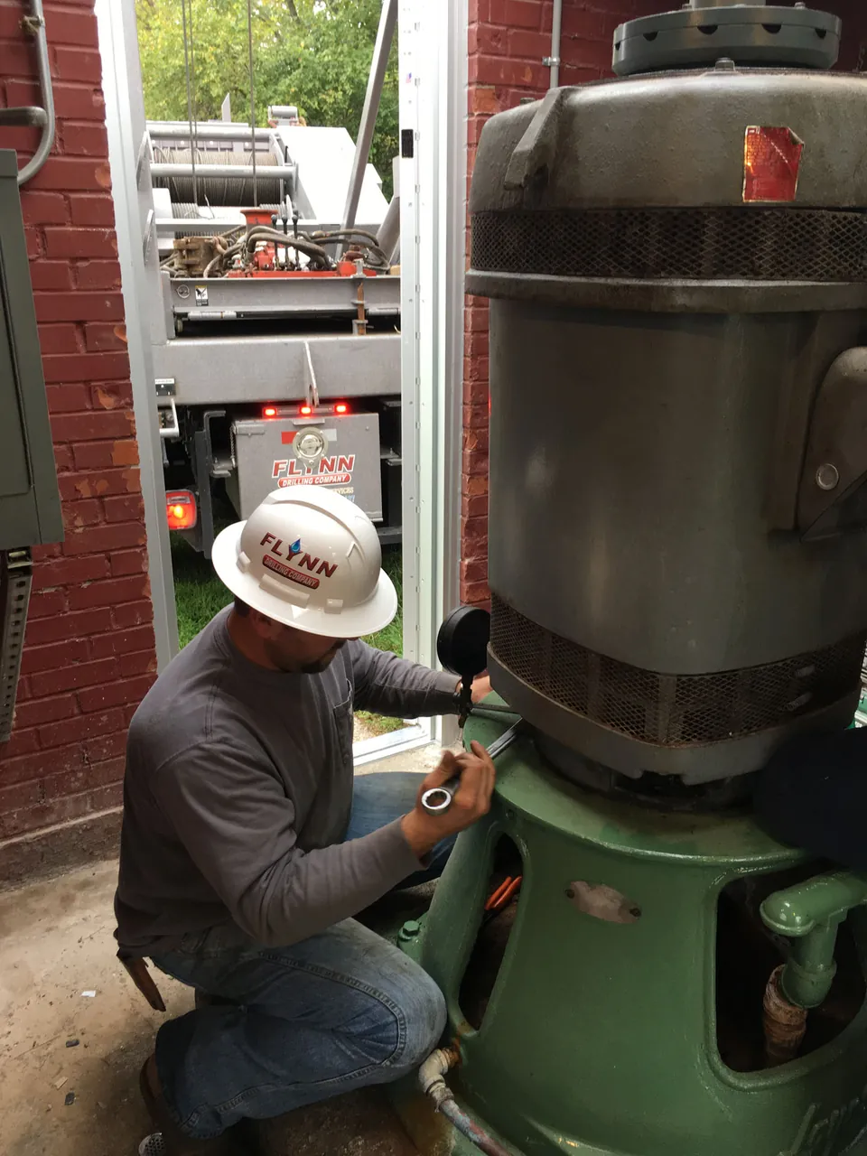 A Flynn technician servicing a municipal vertical turbine pump motor