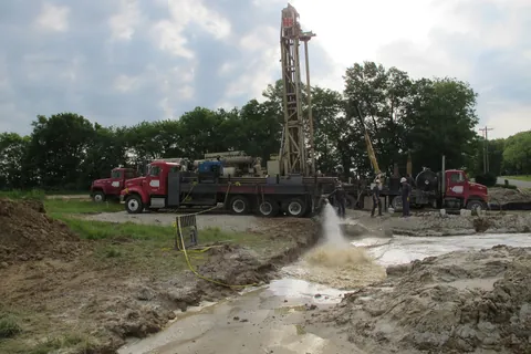 A newly drilled well flowing under artesian pressure