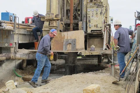 A Flynn drilling crew working a deep rock well